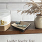 Leather jewelry tray on counter 